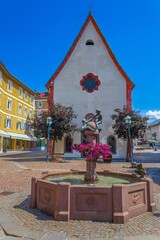Small square with fountain in front of a Sant'Antonio church. Ortisei, South Tyrol, Italy