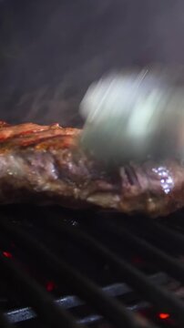 Steaks are roasted on a Josper oven. Frying a steak on a josper - Vertical video.