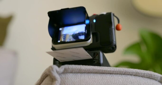 Action camera with a portable printer attachment enabling instant photo printing. This setup is perfect for capturing memories on the go and sharing experiences immediately with friends.