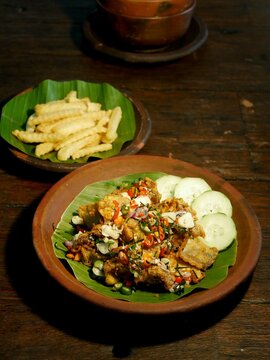 A modern twist on Indonesian Ayam Geprek featuring crispy smashed chicken with spicy chili paste, served with french fries. Ideal for fast food menus and culinary lifestyle blogs