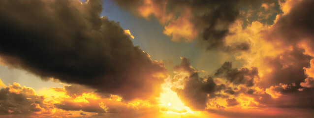 Fiery Sunset Exploding Beneath Massive Dark Clouds, With Intense Golden And Orange Light Flooding The Sky And Casting Dramatic Highlights On The Billowing Cloud Edges Over A Glowing Horizon

