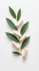 Obraz premium Natural capsules and tablets with green leaves on a white background.
