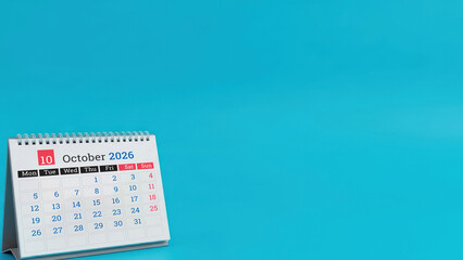 October 2026 desk calendar on blue background with copy space