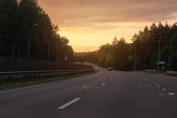 Obraz premium orange evening views of the road highway on a sunny day in summer. 