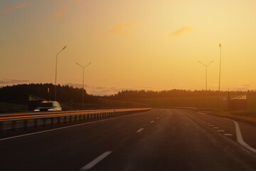 orange evening views of the road highway on a sunny day in summer. 