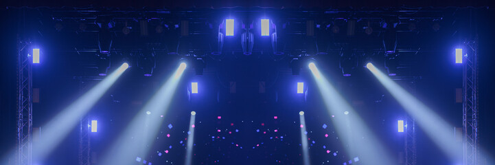 An empty stage of the theater, lit by spotlights and smoke before the performance