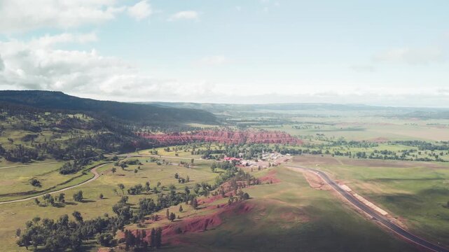 Panoramic aerial view of Devils Tower National Monument at summer sunset, Wyoming from drone perspective