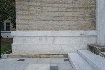 Gray concrete staircase with gray brick wall