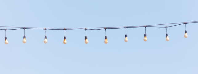 A string of lights hanging from a wire