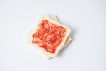 Close-up of white bread with raspberry jam