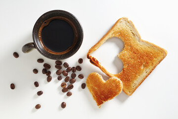 Coffee and toast with heart shape cutout