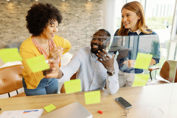 Team collaborating in an office using sticky notes for a creative business meeting