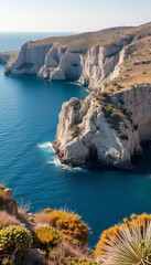 Sun-drenched rocky outcrop emerging from a calm blue sea, rugged cliffs and sparse vegetation,  sea,  coastal
