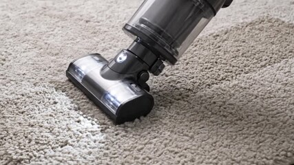 Vacuum cleaner in action on a plush carpet, effectively removing dirt and debris, bright lighting