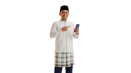 Smiling young man in traditional attire pointing at a smartphone in studio
