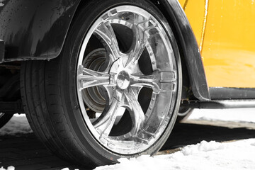 An yellow and black retro car  close up view . low angle view