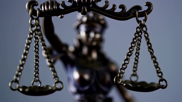 Justice statue symbolizing law, fairness, and judgment against a neutral backdrop