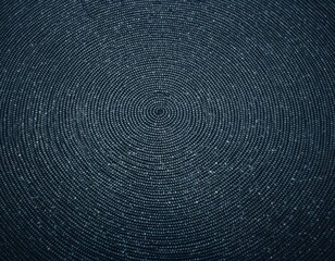Close-up view of a dark textured surface with intricate concentric circular patterns and scattered light specks.