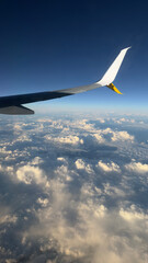 An airplane wing above the clouds over the Mediterranean Sea