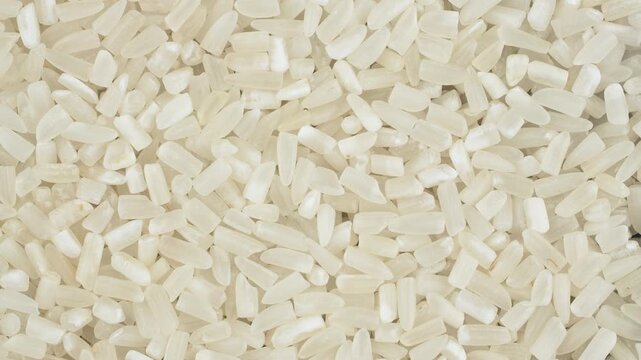 Rotating broken ST25 rice texture. Fractured grain ingredient for Vietnamese Com Tam dish.
