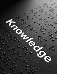 Macro shot of braille letters forming the word &ldquo;Knowledge&rdquo; on dark background with dramatic lighting, symbolizing conceptual education, inclusion, accessibility, and tactile literacy