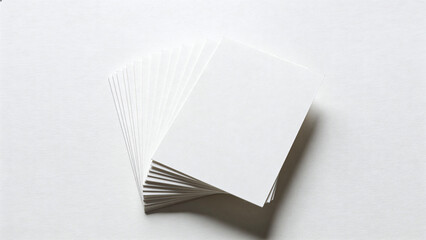 Stack of blank white cards on a light surface