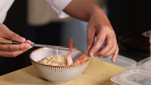 Chef Arranging Japanese Prawn on Rice Bowl with Chopsticks