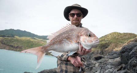 fisherman with a big snapper he has caught