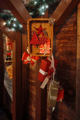 Color photograph of festive Christmas decorations displayed at a traditional wooden Christmas market stall.