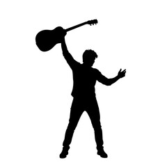Silhouette of a person joyfully raising a guitar above their head