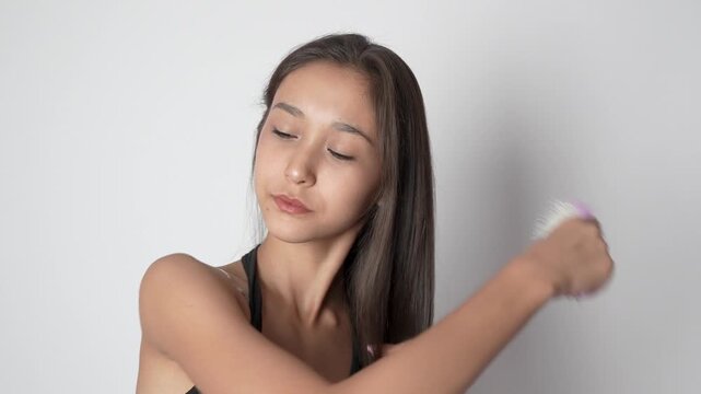 Girl cleaning her clothes with a lint roller.