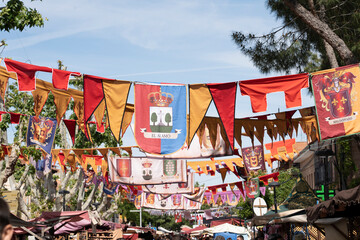 Colorful banners hanging above a market street.