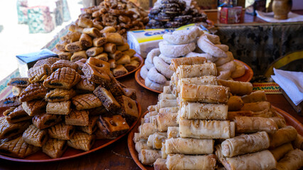 Various pastries arranged in neat piles on tables.