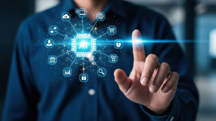 A man interacts with a futuristic interface on his finger in an office setting with technology icons