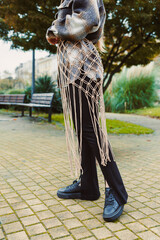 Unique outdoor fashion showcase featuring a creative knot design interweaved with stylish streetwear in an urban park setting during early autumn