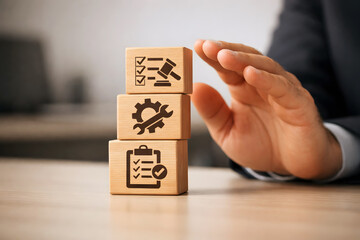 Hand protecting wooden blocks with business process icons