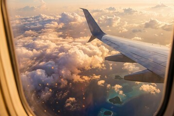Obraz premium Breathtaking Aerial View of Clouds and Tropical Islands from Airplane Window During Sunset