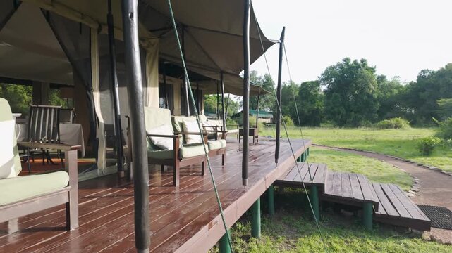 Comfortable outdoor seating on porch of mess tent at Porini Lion Camp, Kenya