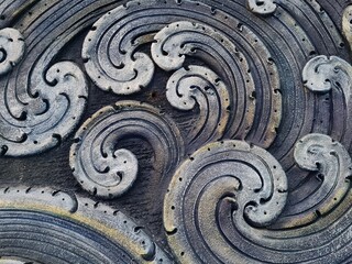 Intricate Stone Carving of Swirling Waves and Ocean Motifs