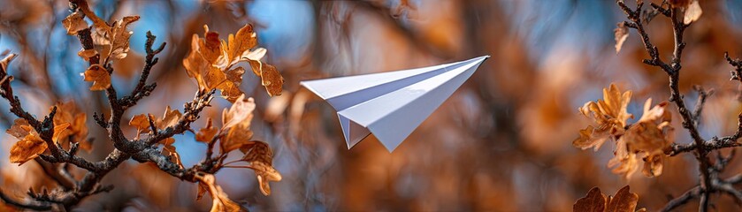A paper airplane glides through autumn leaves, capturing a moment of creativity against a backdrop of vibrant colors and nature.