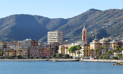 Panoramic view of traditional buildings and structures of Liguria. Mountains of Italy. Mediterranean nature, Europe. Sky, sea, and palm trees of Rapallo. Design backdrop. Tourism and recreation.