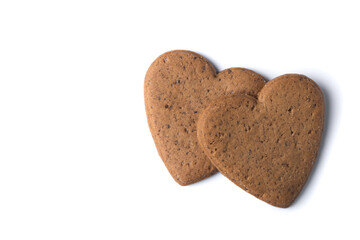 Heart-shaped gingerbread cookies isolated on white background. Top view. Copy space
