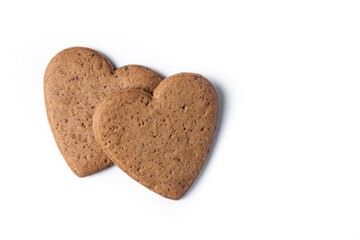 Heart-shaped gingerbread cookies isolated on white background. Top view. Copy space