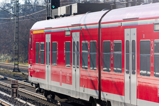 Red S-Bahn train number 7 direction leaving railway station of Zeppelinheim near the Frankfurt Airport on a sunny autumn day. Photo taken November 22nd, 2025, Zeppelinheim, Neu-Isenburg, Germany.
