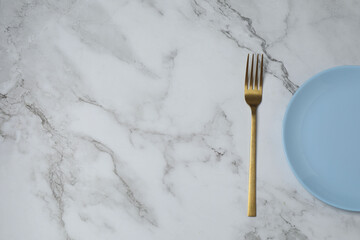 Empty plate and cutlery on colored background, top view
