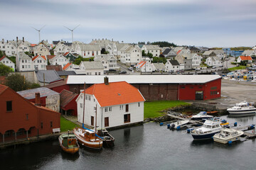 Traditional wooden buildings and boats along the waterfront and the marina. Smedasundet area and river in the center of the town, Haugesund, Norway.