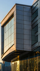 Obraz premium Modern building with large glass windows and sleek exterior panels.