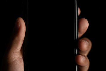close-up of the hand holding an smartphone with a blank black screen
