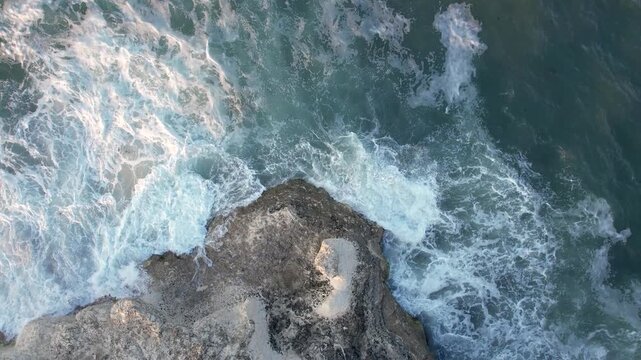 Aerial view of the foamy white waves crashing against the rugged, rocky coastline, creating a mesmerizing contrast of textures and tones, Lozenets, Tsarevo, Bulgaria.