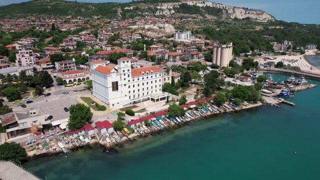 Aerial view of the urban landscape, where white buildings contrast with the turquoise waters and the boats docked along the coast, Balchik, Dobrich Province, Bulgaria.